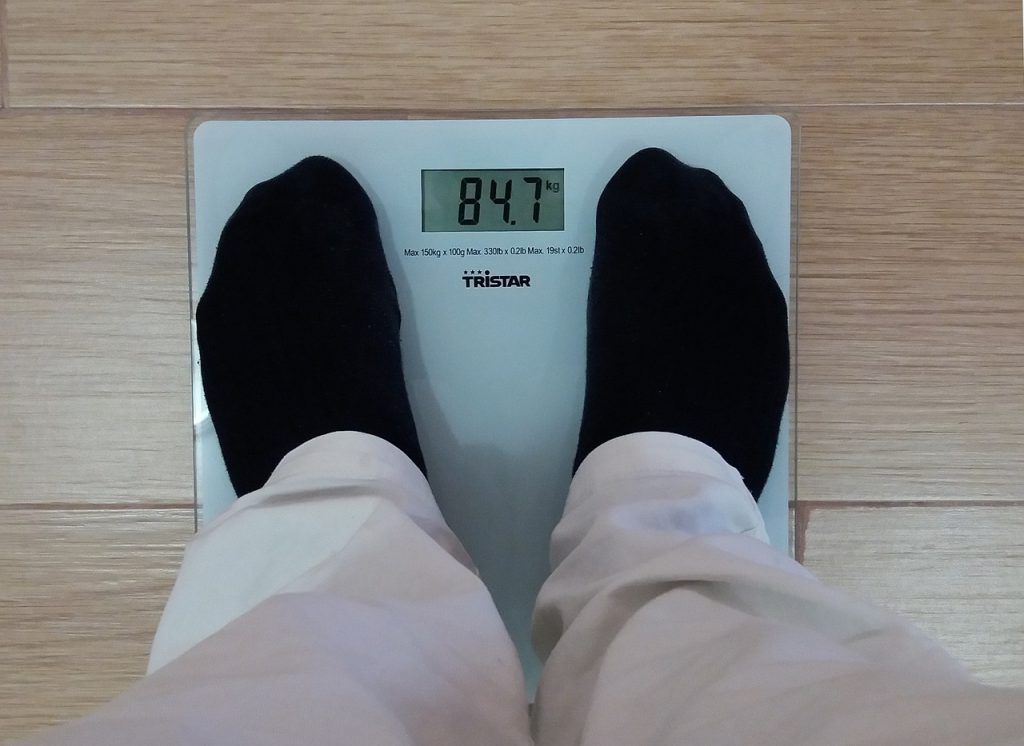 man weighing bmi