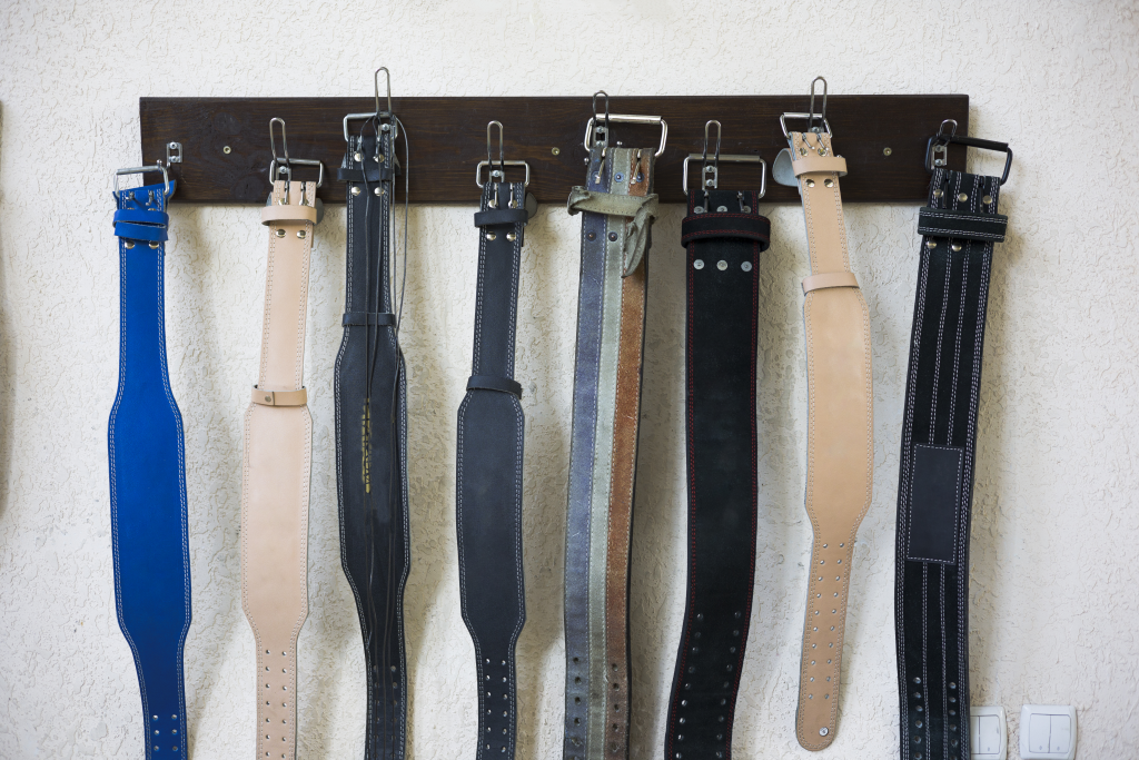 example of deadlifting belts hanging in a gym